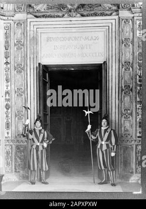Rome: The Pontifical Swiss Guard in Vatican City  Two guards at a gate made in 1859 under Pope Pius IX giving access to the then private quarters of the Pope on the 1st floor Date : 1938 Location: Italy, Rome, Vatican City Keywords: buildings, military, palaces, uniforms, weapons Stock Photo
