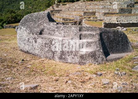 Mortuary Rock or Funerary Stone in Machu Picchu Inca Citadel in Peru Stock Photo