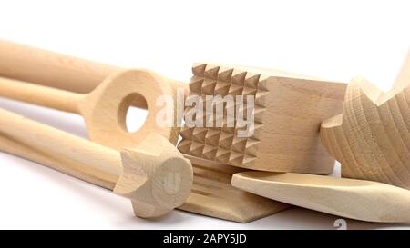 Various wooden kitchen utensils against white background Stock Photo