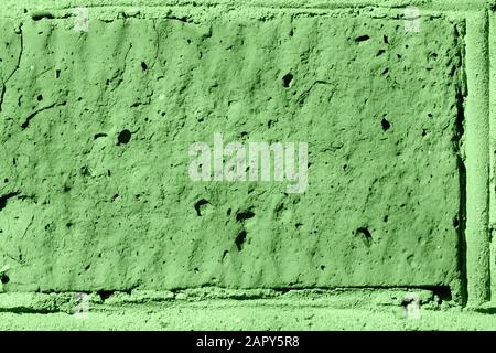 Brick wall texture close-up lit by the sun. Abstract background green color toned Stock Photo