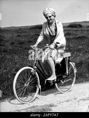 Queen Juliana and Prince Bernhard visited Terschelling on 11 July 1967. She takes this opportunity to take a bike ride in the nature reserve De Bosplaat. Stock Photo