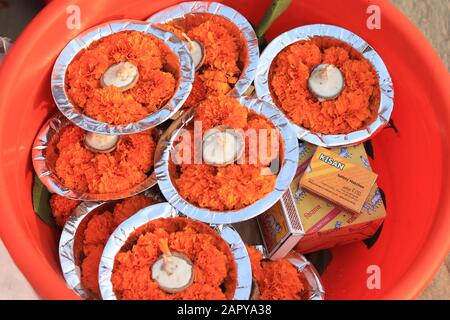 Marigold flowers and candles as offering to Ganges river Stock Photo