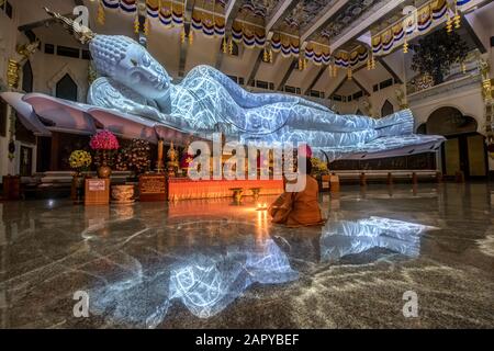 The biggest white marble nirvana buddha with the texture from lighting at Wat Pa Phu Kon, Udon Thani Thailand Stock Photo