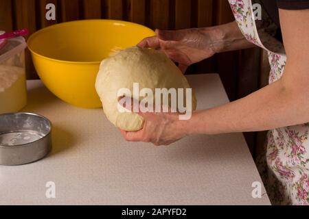 Female hands making dough in the kitchen at home Stock Photo