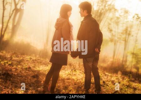 Attractive asian couple spending time together in the park Stock Photo