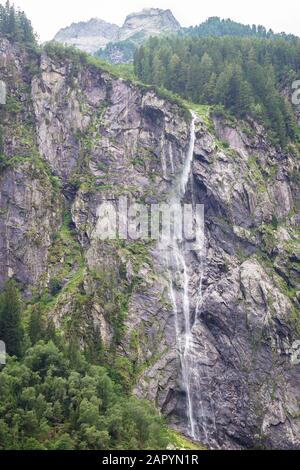 Small but high waterfall from a mountain in the Alps Stock Photo