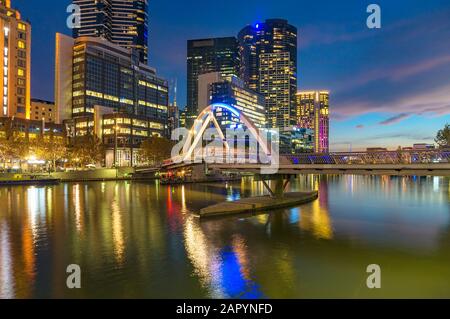 Beautiful Melbourne Southbank cityscape at night with Evan Walker pedestrian bridge across Yarra river. Victoria, Australia Stock Photo