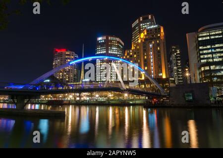 Southbank pedestrian bridge over Yarra river and Southbank cityscape at night. Melbourne, Australia Stock Photo