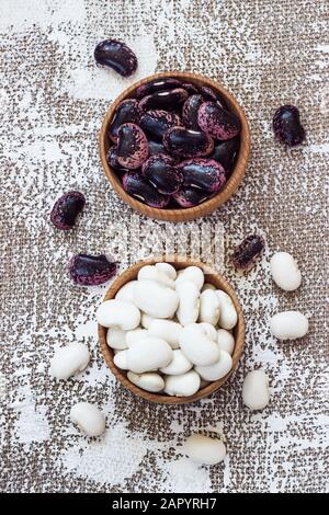 Different types of legumes - Cannellini Beans, Black and Red Kidney Beans, Lima and Pinto Beans had sorted in wooden bowls. Stock Photo