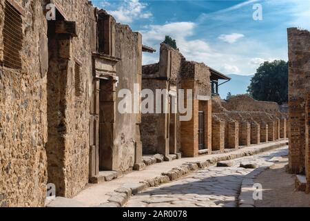 A street in the antique ruins of pompei, city destroyed by the vesuvius volcano eruption in Italy, site inscribed on the world list heritage of UNESCO Stock Photo