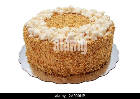 Cake piece with macaroons, chocolate, milk cream, nuts on white background. Stock Photo