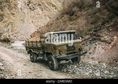 Old Soviet Russian Medium-duty Truck On Mountains Country Road. Truso Gorge, Kazbegi District, Mtskheta-Mtianeti Region, Georgia. Stock Photo