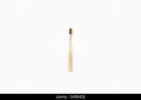 Zero waste picture. Wooden toothbrush on isolated white background. Flat lay, top view. Stock Photo