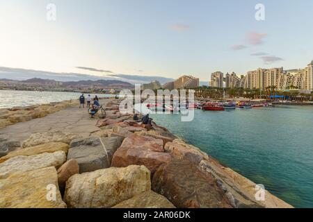 Eilat, Israel - January 17, 2020: Sunset scene of the new marina and hotels, with locals and visitors, in Eilat, southernmost city in Israel Stock Photo