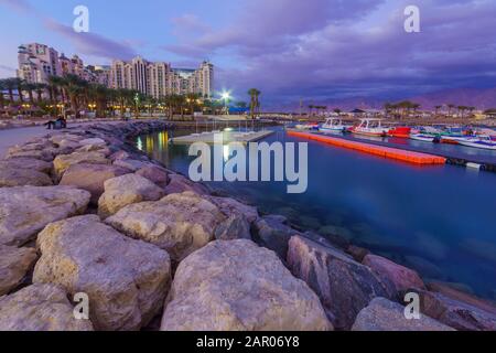 Eilat, Israel - January 17, 2020: Evening scene of the new marina and hotels, with locals and visitors, in Eilat, southernmost city in Israel Stock Photo