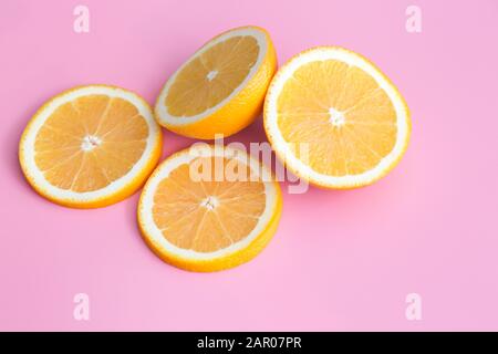 Slice of fresh orange isolated on pink background Stock Photo