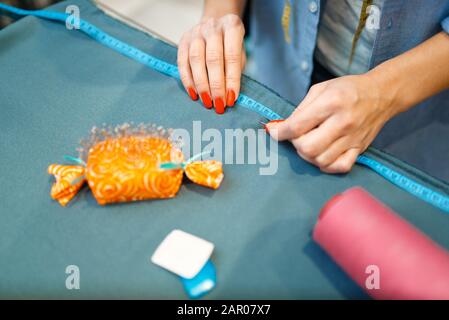 Seamstress measures fabric material, top view Stock Photo