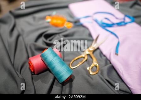 Fabric, thread, and scissors in textile store Stock Photo