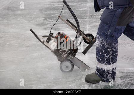 Sawing machine on the ice of a frozen lake Stock Photo