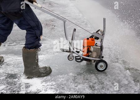 Sawing machine on the ice of a frozen lake Stock Photo