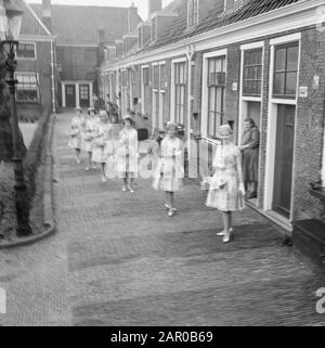 Haarlem flower girls in new suit, their new Boussac cotton dresses. Some girls at the Proveniershofje in Haarlem Date: March 18, 1963 Location: Haarlem Keywords: FLOWER GIRLS Stock Photo