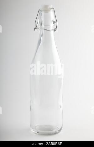 empty bottle with metal mechanism for plastic stopper photographed on white background Stock Photo