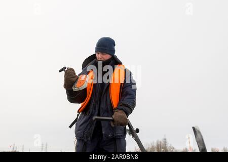 Sawing machine on the ice of a frozen lake Stock Photo