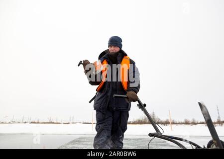 Sawing machine on the ice of a frozen lake Stock Photo