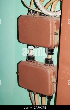 Old metal boxes for electrical wires on the wall Stock Photo
