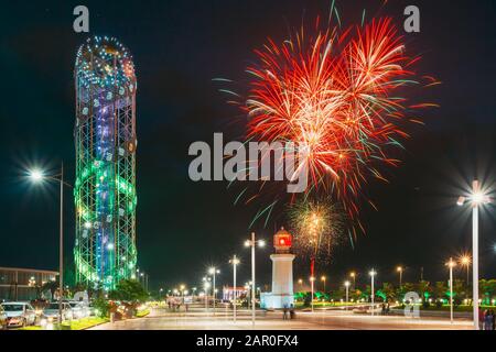 Batumi, Adjara, Georgia. Festive Salute During Celebration Of Georgia's Independence Day Over Illuminated Alphabet Tower And Pitsunda Lighthouse At Pr Stock Photo