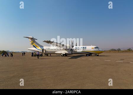Passengers disembarking and luggage being unloaded from Air KBZ airplane at Heho airport near Inle Lake, Myanmar (Burma), Asia in February ATR 72-600 Stock Photo