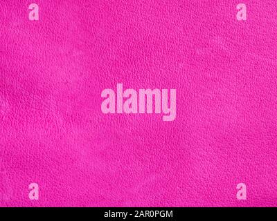 Background with leather texture. Pink piece of natural tanned calfskin painted and treated with fuchsin paint. Lots of detail, frontal shot with macro Stock Photo
