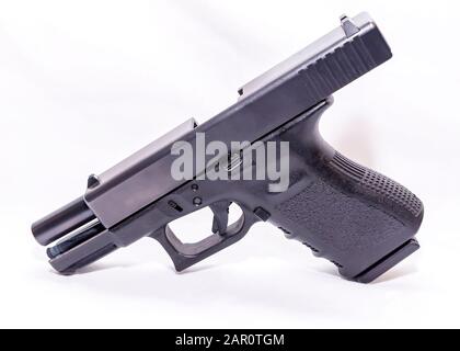 A black 9mm semi automatic pistol with an opened slide on a white background Stock Photo