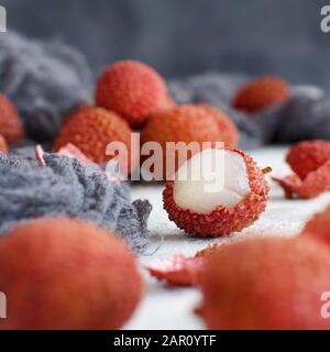 Fresh litchi fruits on a white table close up Stock Photo