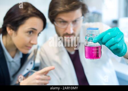 two scientists doing experiments with chemical liquid in the lab Stock Photo