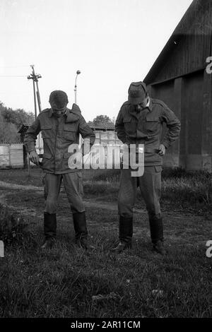 STUPINO, MOSCOW REGION, RUSSIA - CIRCA 1992: The portrait of two soldiers of the Russian army. Black and white. Film scan. Large grain. Stock Photo