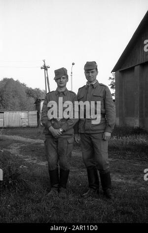 STUPINO, MOSCOW REGION, RUSSIA - CIRCA 1992: The portrait of two soldiers of the Russian army. Black and white. Film scan. Large grain. Stock Photo