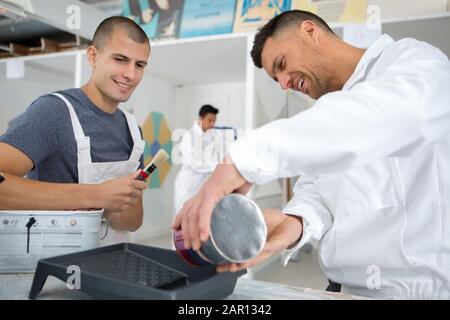 a painter with an apprentice Stock Photo