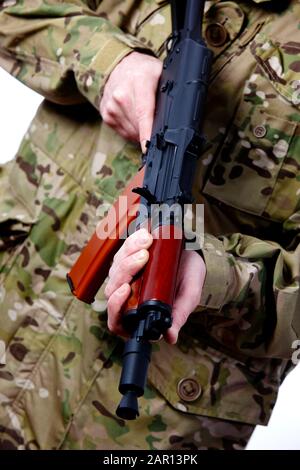 man in combat fatigues holding aks-47u close quarter combat kalasknikov rifle Stock Photo