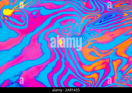 Abstract trendy neon colored psychedelic fluorescent striped zebra textured neon background Stock Photo