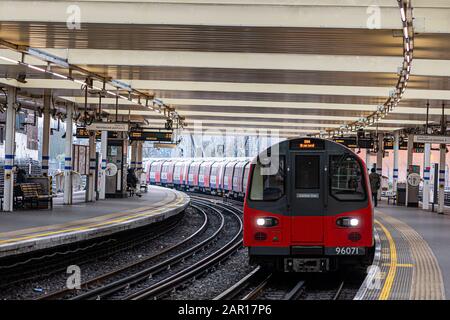 London, UK - January 1, 2020: A London Overground Train approaches the Eastbound platform at Finchley Road Station Stock Photo