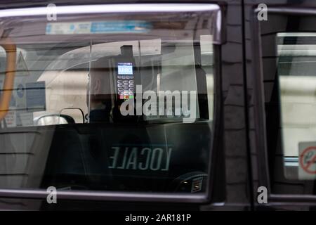 London, UK - January 1, 2020: An abstract view through a taxi window to a bank terminal for payment for a London taxi ride Stock Photo