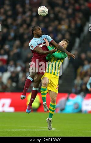 West Ham United's Michail Antonio (left) and West Bromwich Albion's Dara O'Shea clash during the FA Cup fourth round match at the London Stadium. Stock Photo