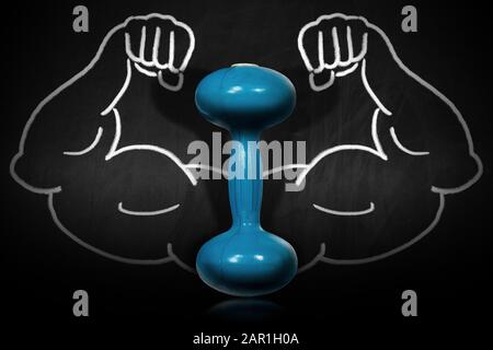 Close-up of an old blue dumbbell for weight training on a blackboard with a chalk drawing of muscular arms Stock Photo