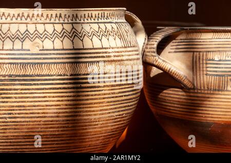 A museum display of early Greek ceramics, Geometric Kraters, funerary urns, from 750-720bc.  from graves at Ancient Corinth, Peloponnese, Greece. Stock Photo