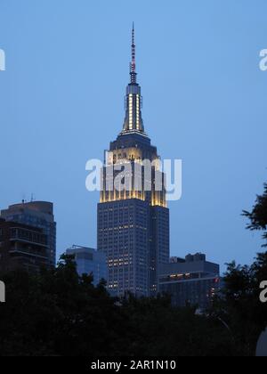 New York, USA - June 2, 2019: Image of the Empire State Building towering over its surroundings at dusk. Stock Photo