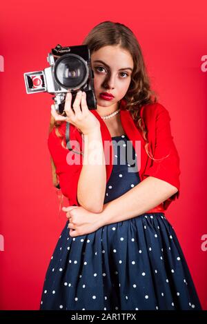 Professional camera. Girl with retro camera. Capture moments. SLR camera. Learn use presets. Courses for photographers. Education for reporters and journalists. Editing photos. Manual settings. Stock Photo