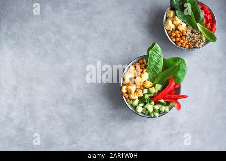 Fried Tofu Salad with Cucumbers, Fried Chickpeas, Leaves vegetables and Sesame Seeds. Balanced vegan colorful salad for healthy lunch in ceramic bowl, Stock Photo