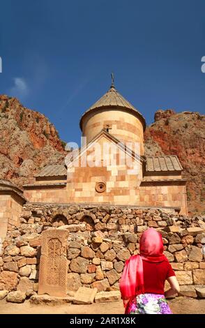 Female Visitor Admiring the Surb Karapet or St. John the Baptist Church at Noravank Monastery Complex, Armenia Stock Photo