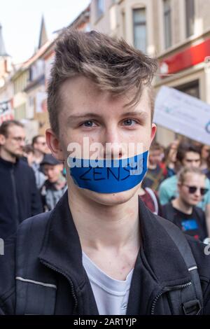 ERFURT, GERMANY - Mar 23, 2019: Young teenager man isolated taped mouth due to 'censorship' at 'Artikel 13' protest demo rally against new copyright l Stock Photo